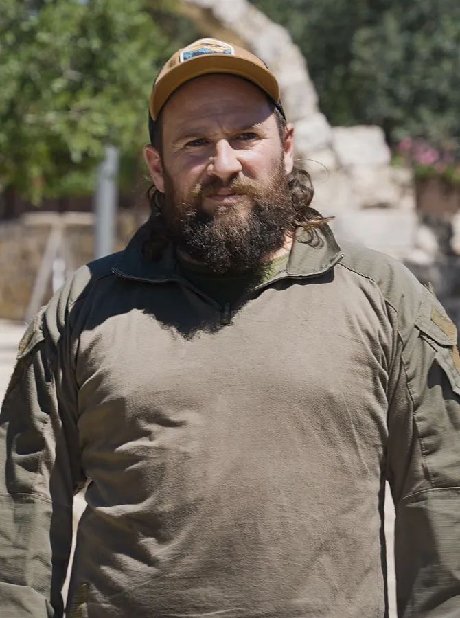 An IDF soldier looking stoically into the camera