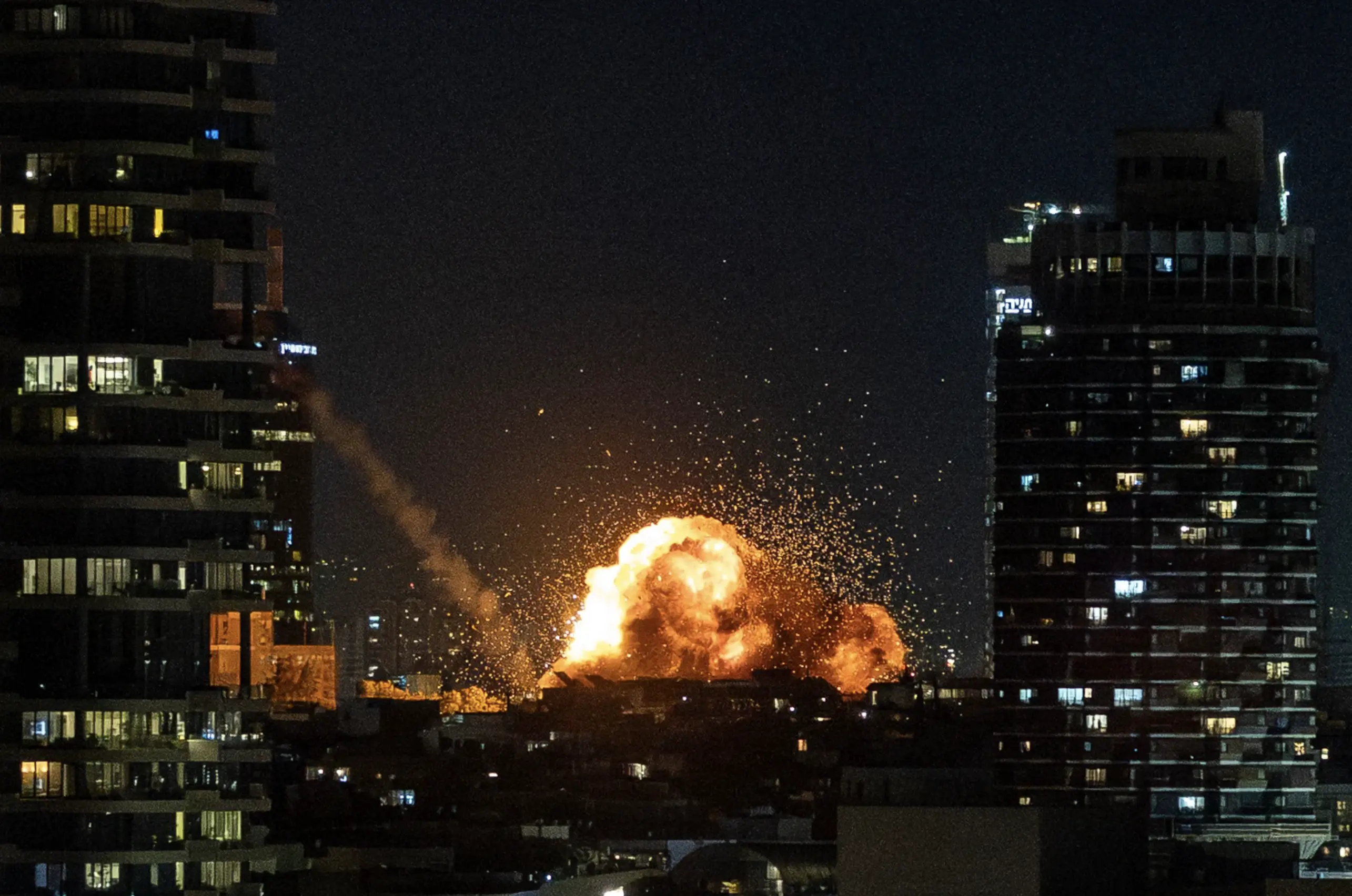 An explosion is seen in the dark skyline in Israel