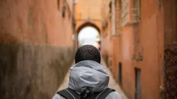 man standing in an ally