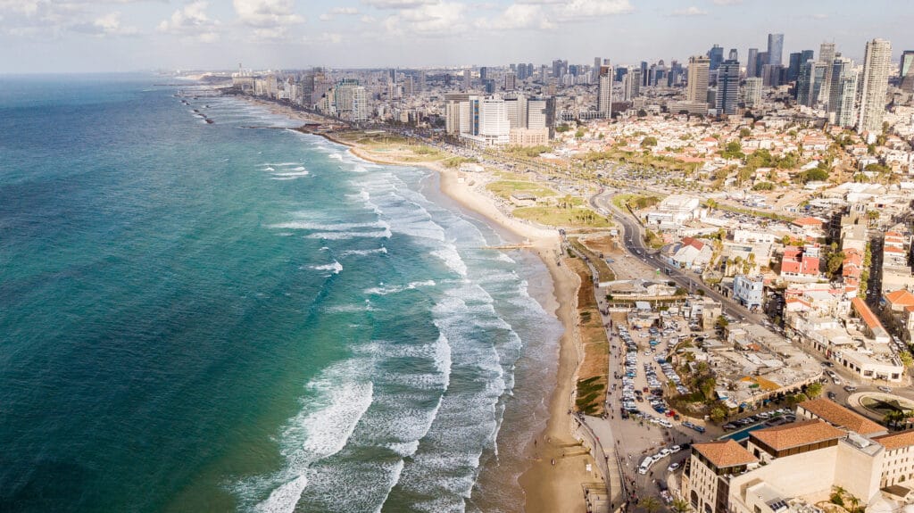 aerial view of big city with sandy seashore and wavy sea, Tel Av