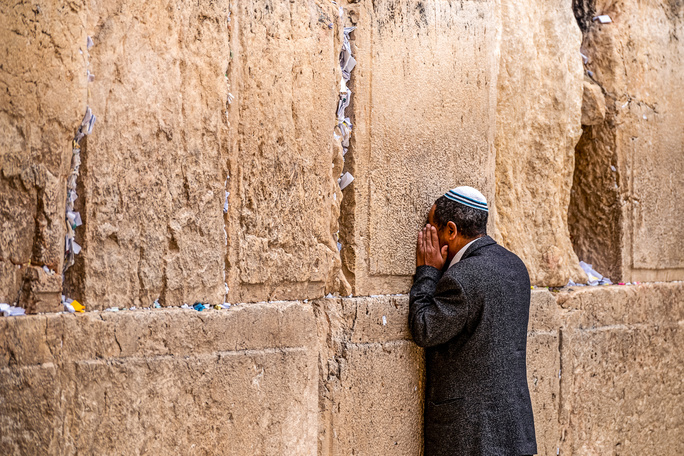 man praying at the western wall