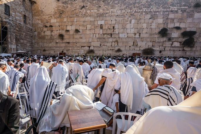 Jewish men praying at the Western Wall