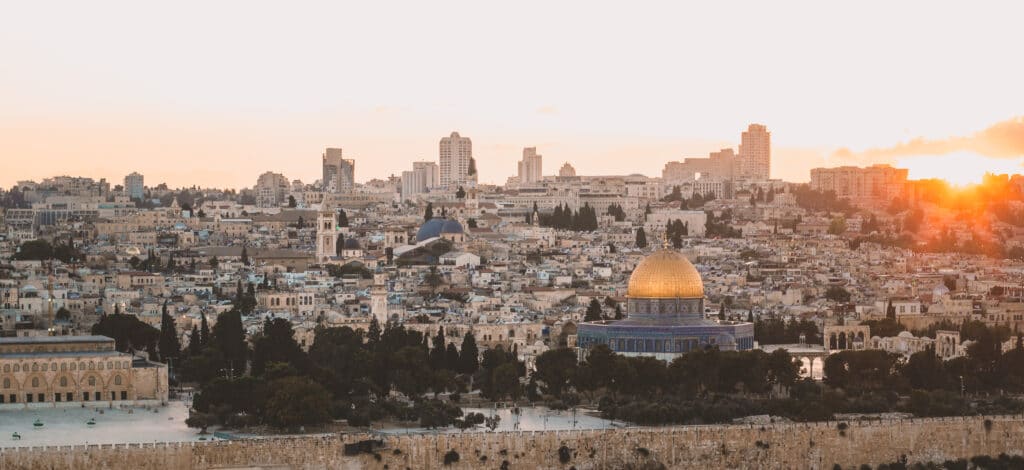 pilgrimage religion destination place Jerusalem old city panorama landmark view in evening sun set time with stone houses and gold dome