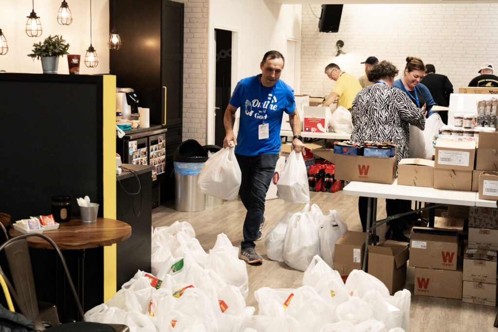Believers pack grocery boxes for displaced Israelis as part of the Hope & Healing: How Up and Serve Trip