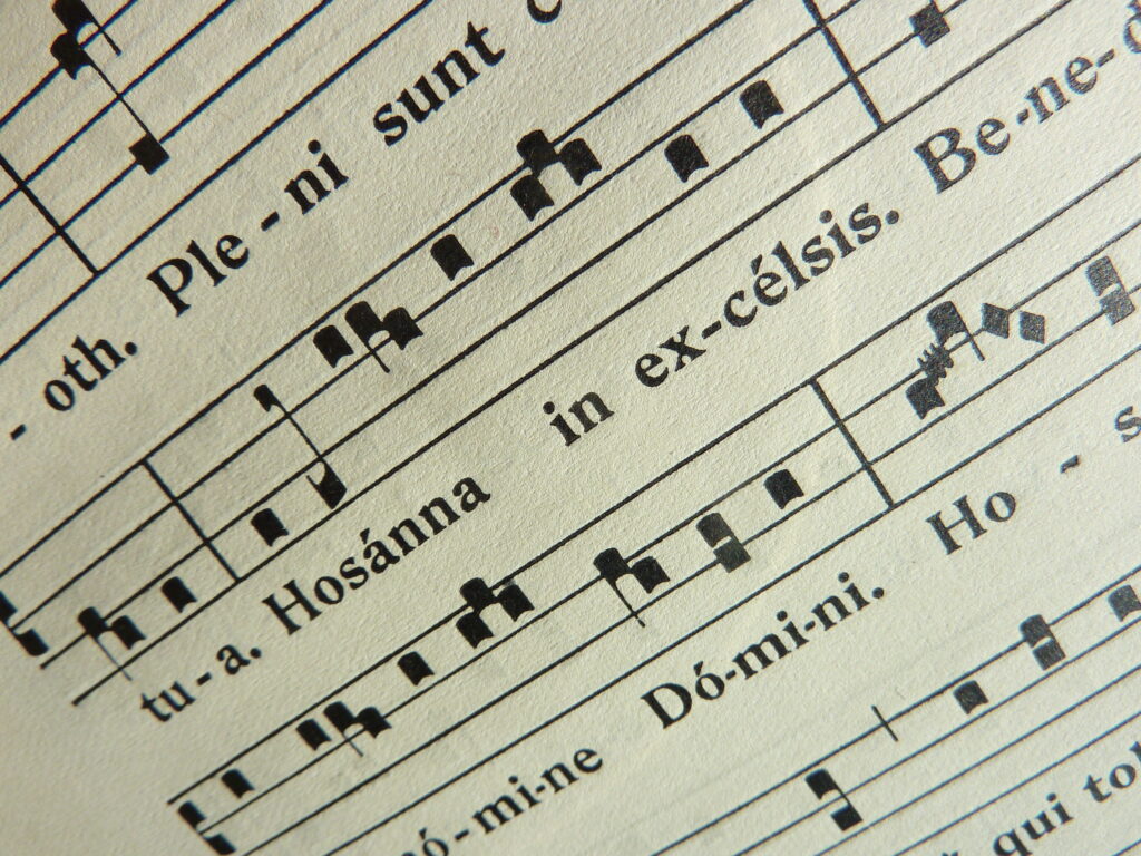 Hosanna on a sheet of music. What does the word Hosanna actually mean?