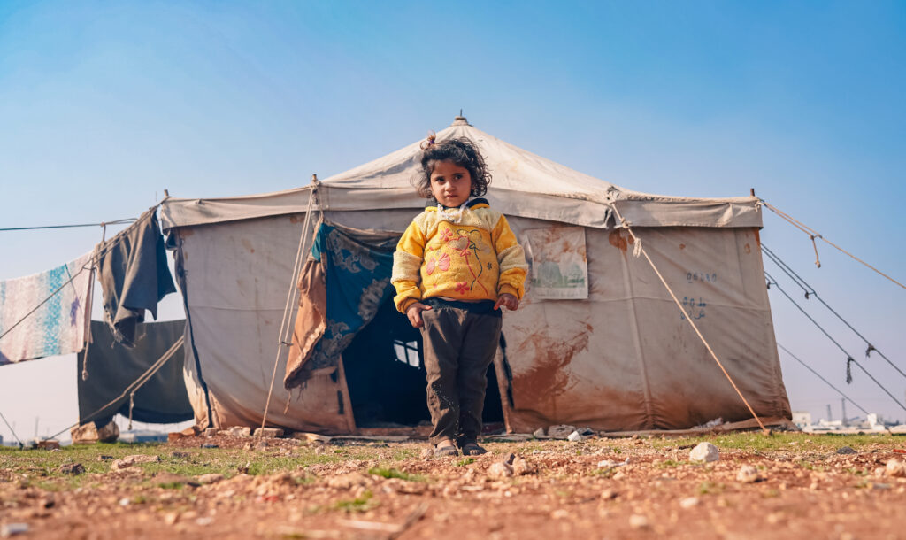 Arab child next to a tent