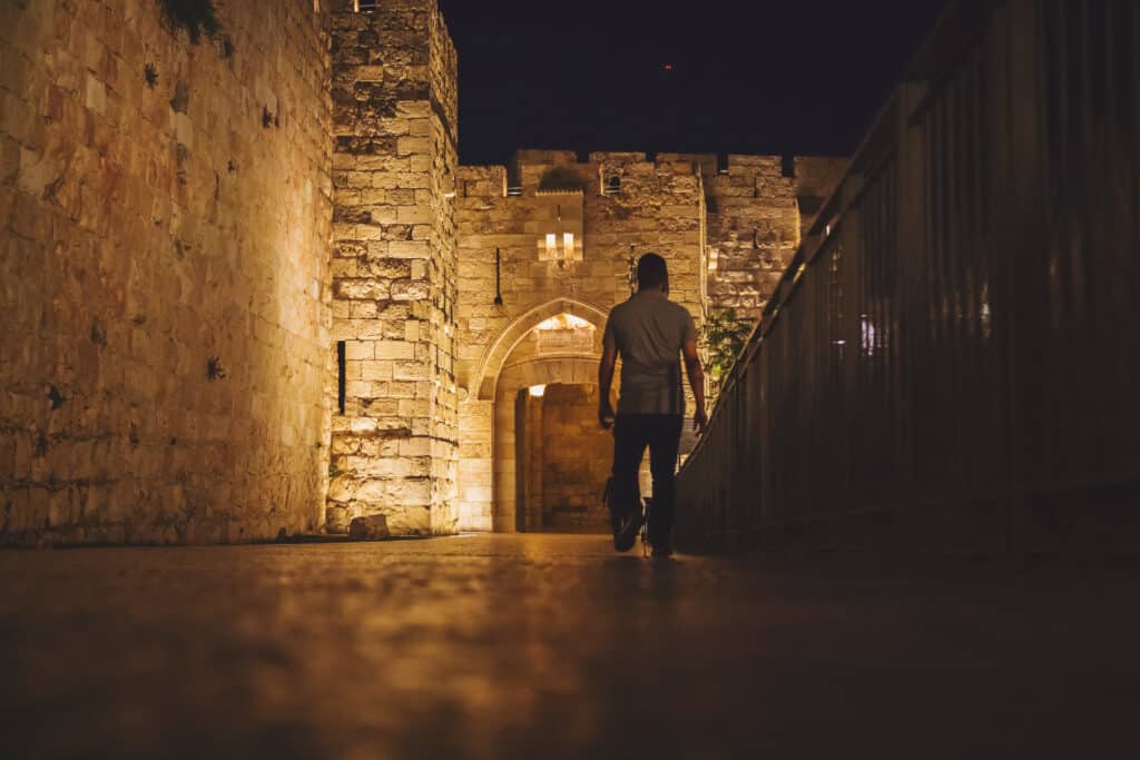 Man walking near Jaffa gate at night, Jerusalem, Israel